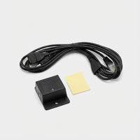 Black sensor device with cable and yellow label on a white background